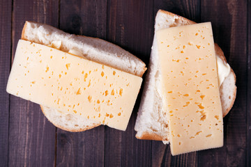 Two homemade cheese sandwiches on wooden background