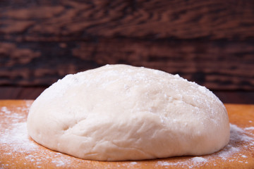 Dough on wooden background