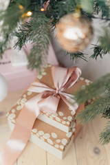 a toy and a gift under a Christmas tree