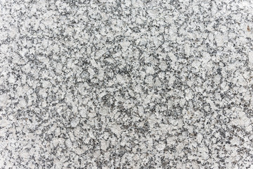 Textured surface of speckled grey granite rock