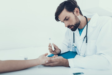 Doctor Taking Blood Sample from Boy's Finger.