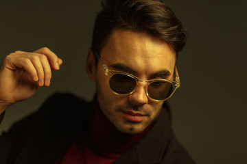 Portrait of a stylish man in sunglasses. Creative color