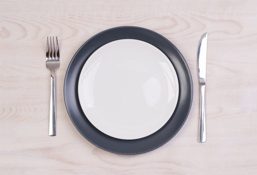 Empty plates on wooden background
