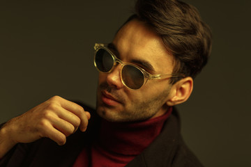 Obraz premium Portrait of a stylish man in sunglasses. Creative color
