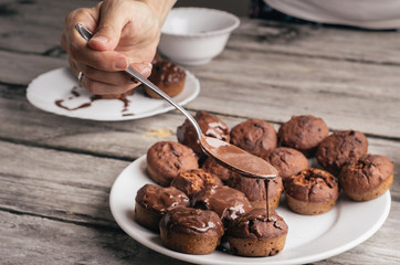 Covering homemade muffins with chocolate 