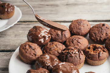 Covering homemade muffins with chocolate