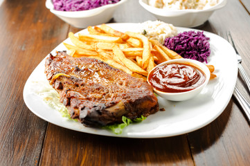 baked ribs and French fries and cabbage salad