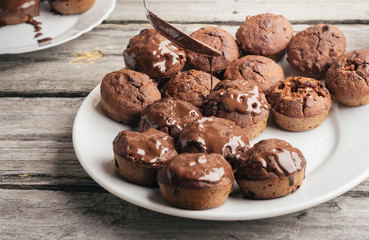 Covering homemade muffins with chocolate