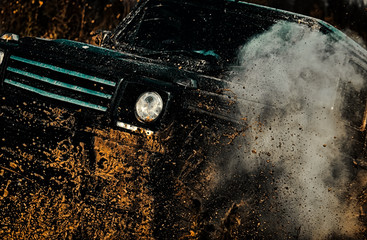 Travel concept with big 4x4 car. Rally racing. Tracks on a muddy field. Off-road vehicle goes on the mountain. Expedition offroader. © Volodymyr