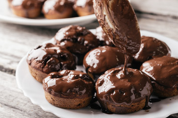 Covering homemade muffins with chocolate