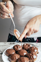 Covering homemade muffins with chocolate 