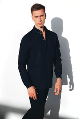 Obraz na płótnie Canvas Male model, man on a white background, guy in a black shirt, handsome man