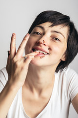Young beautiful woman licking the chocolate of her fingers