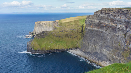Fototapeta na wymiar view of the Cliffs of Moher looming over the Atlantic Ocean in County Clare, Ireland