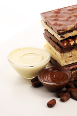 Chocolate bars on table with chocolate tower.