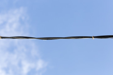 electrical wire against the bkue sky.