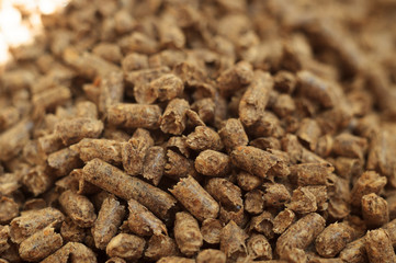 Fuel wood pellet close-up. A source of alternative clean energy. A lot of pellet. Natural fuel and energy of future.