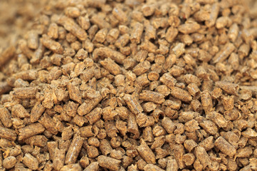 Fuel wood pellet close-up. A source of alternative clean energy. A lot of pellet. Natural fuel and energy of future.