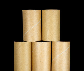 round cardboard tube isolated on a black background
