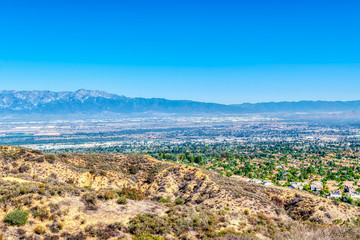 Clear day in valley with houses and blue sky