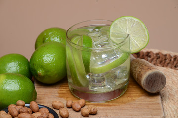 Refreshing cocktail with green lemon and ice.