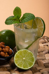 Refreshing cocktail with green lemon and ice.