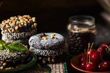 different types Brownie Cookies and table setting Sweet biscuits in dark. Homemade pastry 
