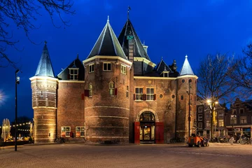 Foto op Canvas AMSTERDAM, NETHERLANDS - APRIL 11, 2018: The Waag ("weigh house") in Nieuwmarkt square at night, Amsterdam, The Netherlands. The historic building was originally a city gate. © Tania Zbrodko