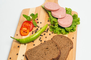 Tasty sausage and bread with lettuce and tomato for lunch