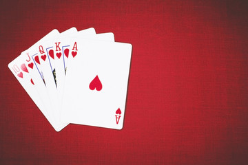 Cards for Poker on a red background, poker hands royal flush.