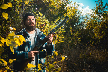Poacher with Rifle Spotting Some Deers. Illegal Hunting Poacher in the Forest. Hunter with shotgun...