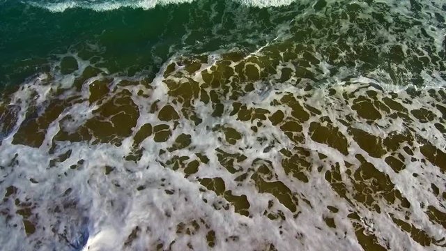 Aerial view of the sea beating the waves