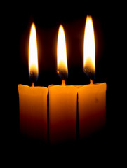 candle lit brightly against a black background