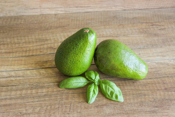 Avocados on a wooden table. Healthy food, diet. Two avocados