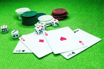 Poker cards on a green table with dice and chips