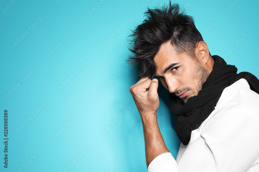 Canvas Prints Young man with trendy hairstyle posing on color background