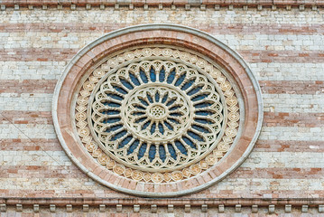 Fototapeta na wymiar Rose window of the Basilica of Saint Clare, Assisi, Italy