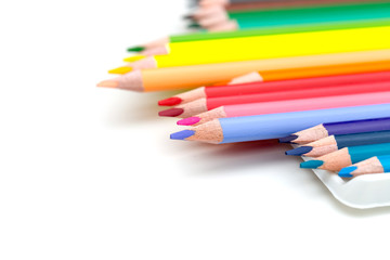 Colored pencils on white background