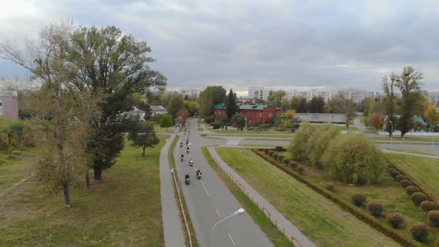 The view from the air on a lot of motorcyclists riding around the city. 4K