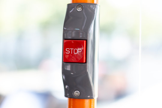 a red stop button in a electric bus