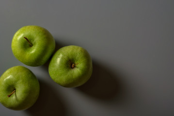 green apples on grey background