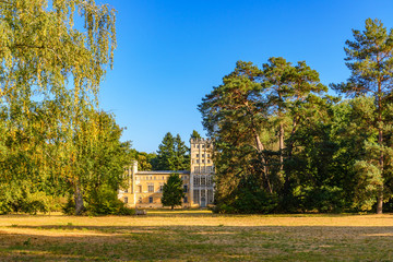 Scenery of the house, Kavaliershaus, surrounded by tree at Pfaueninsel, Peacock island, located on Wannsee lake in Berlin, Germany in Autumn season and sunset light.