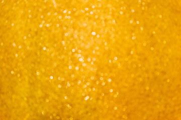 Gold glitter abstract lights background. Christmas yellow blurred bokeh