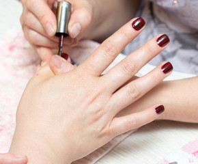 Obraz na płótnie Canvas Gentle care of nails in a beauty salon