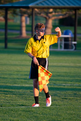 Soccer referee with the sun in his eyes