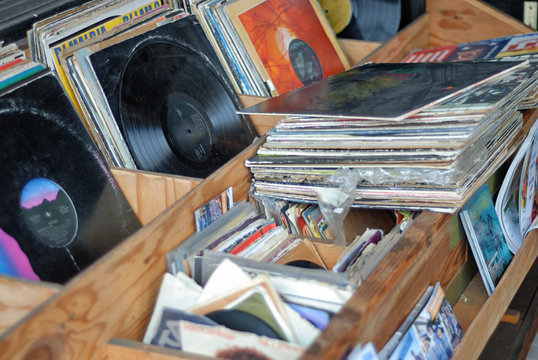A collection of vinyl record albums for sale.