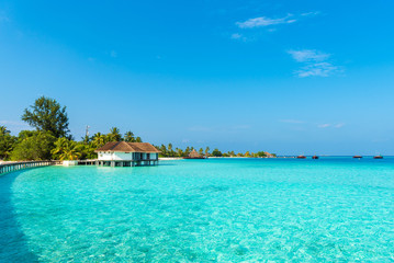 Water villa in a row by the seashore, Maldives. Copy space for text.
