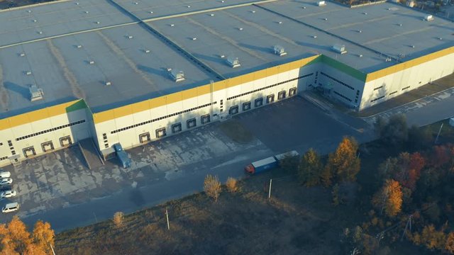 Aerial view of a modern logistic warehouse with ramps for trucks