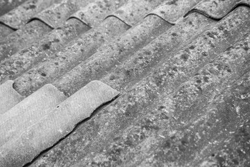 Texture of gray wavy slate on the roof, close