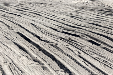 Traces of trucks on the black ground